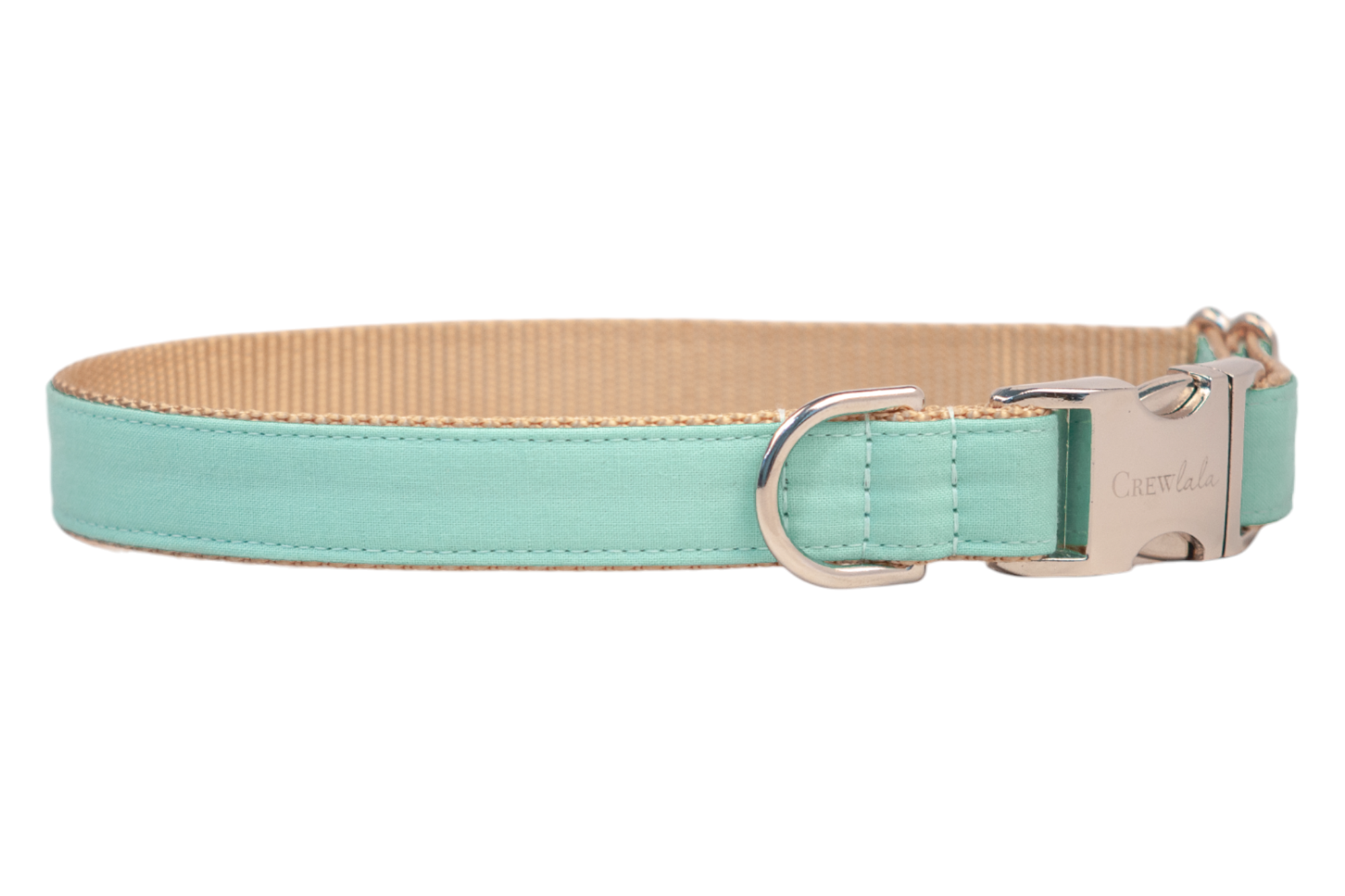 A dog collar with a mint green fabric overlay and tan woven nylon backing. The collar features neat stitching, a silver D-ring for leash attachment, and a polished silver side-release buckle engraved with “Crewlala.”