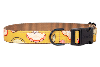 Yellow fabric dog collar with citrus wedges, stylized oysters with wavy pink-edged shells. The collar is lined with vivid pink webbing and fitted with black hardware and a secure side-release plastic buckle.