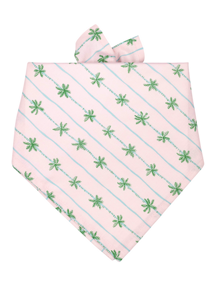 Soft pink bandana for dogs, decorated with slanted rows of small green palm trees and light blue lines, neatly folded.