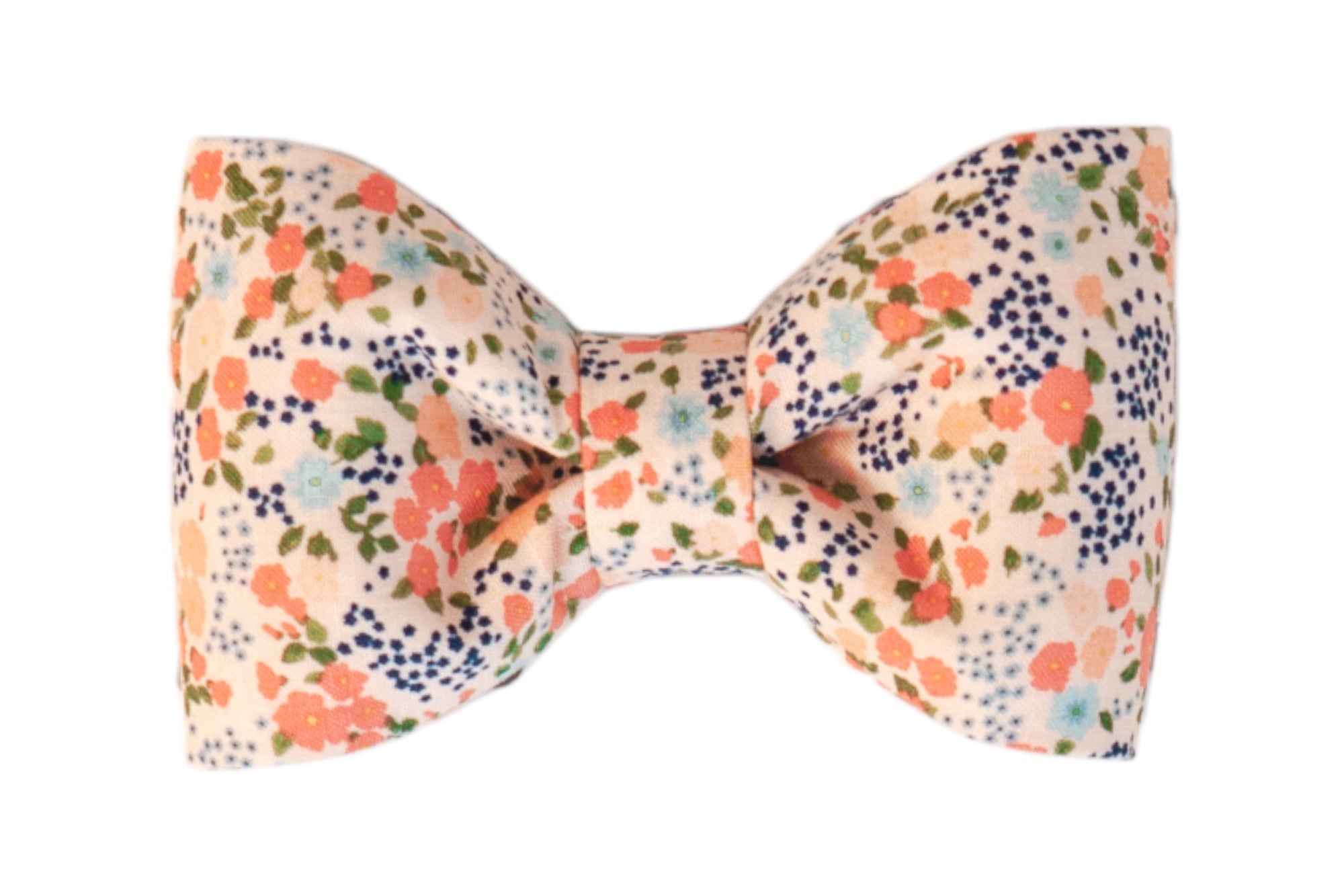 Fabric bow tie with a soft peachy pink background, decorated with a scattered floral print with small leaves, tied in a symmetrical shape with a cinched center. The perfect addition to your dogs fall wardrobe.