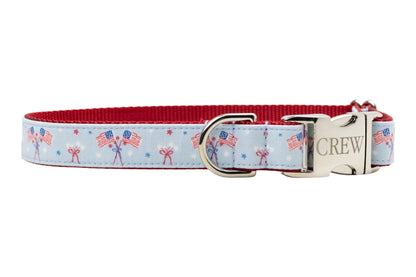 Blue pet collar with a red interior and festive flag print, showcasing durable fabric and a polished silver clasp and ring.