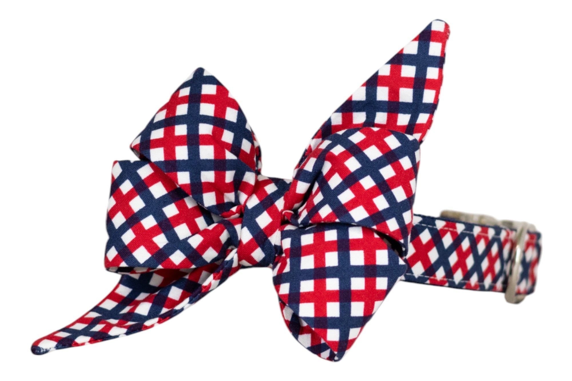 Patriotic-themed dog collar with a decorative belle bow, featuring a red, white, and blue plaid design. The collar includes an adjustable silver buckle for secure fastening.