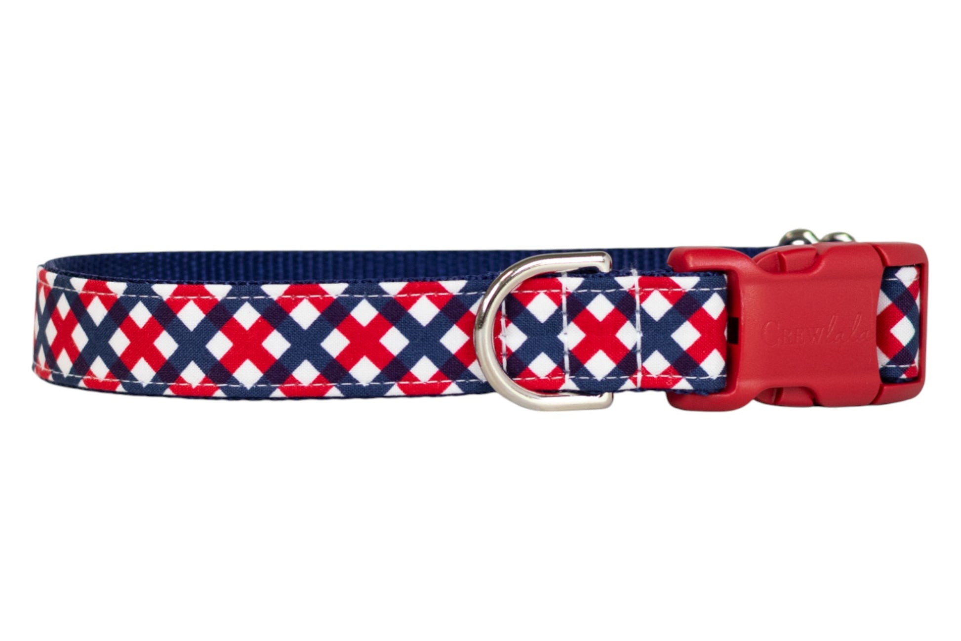 Close-up of a dog collar with a bold red, white, and navy blue patriotic plaid design, complete with a silver metal D-ring and red buckle.