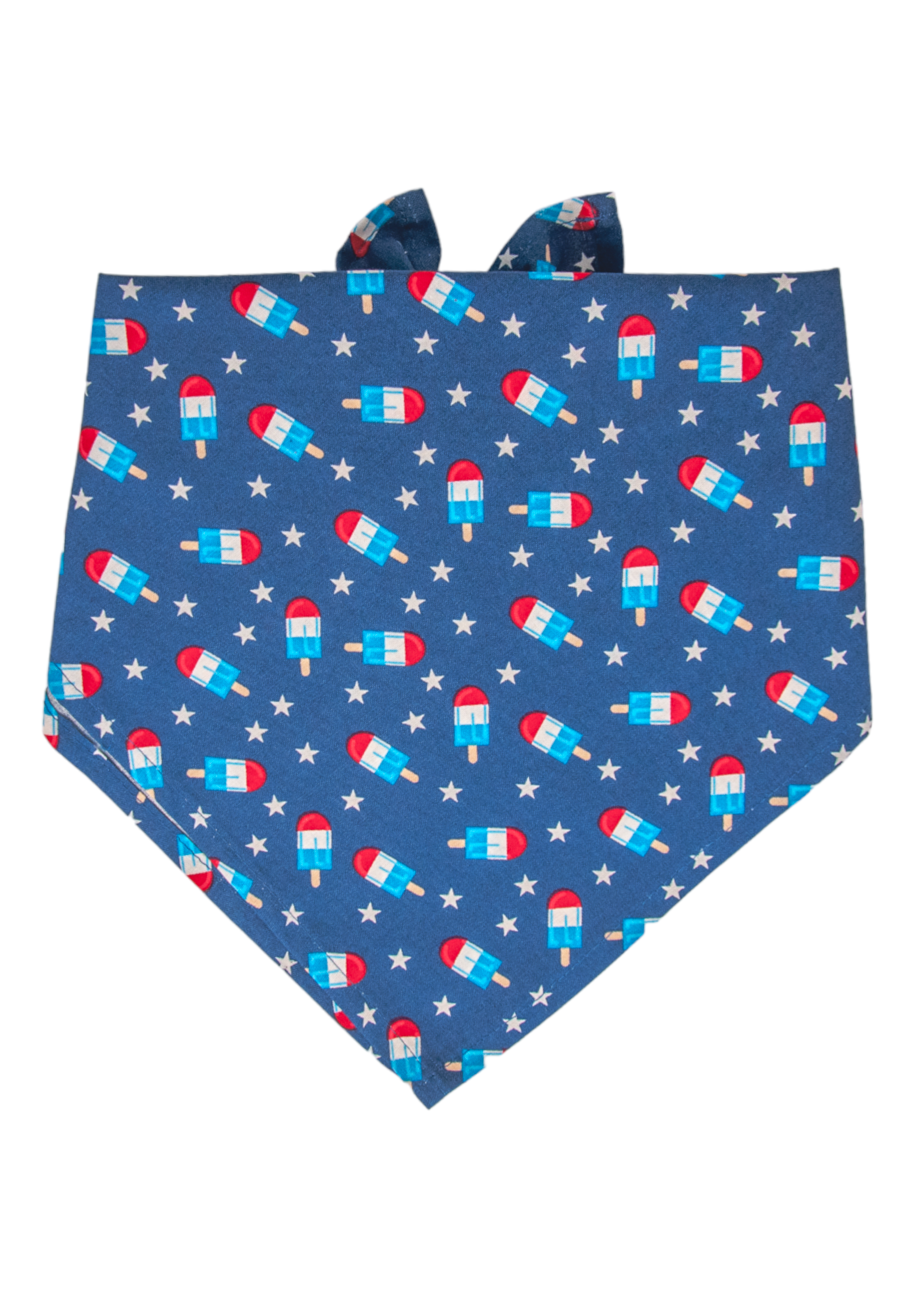 A patriotic-themed dog bandana with a vivid blue background, decorated with red, white, and blue popsicles and scattered white stars. 