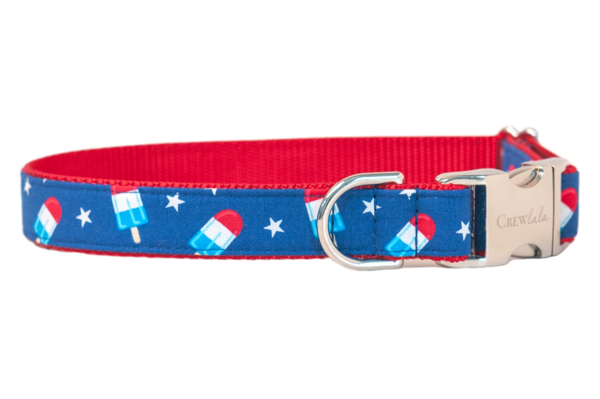 Close-up of a vibrant dog collar with red interior webbing and a blue outer layer decorated with red, white, and blue popsicles and white stars.