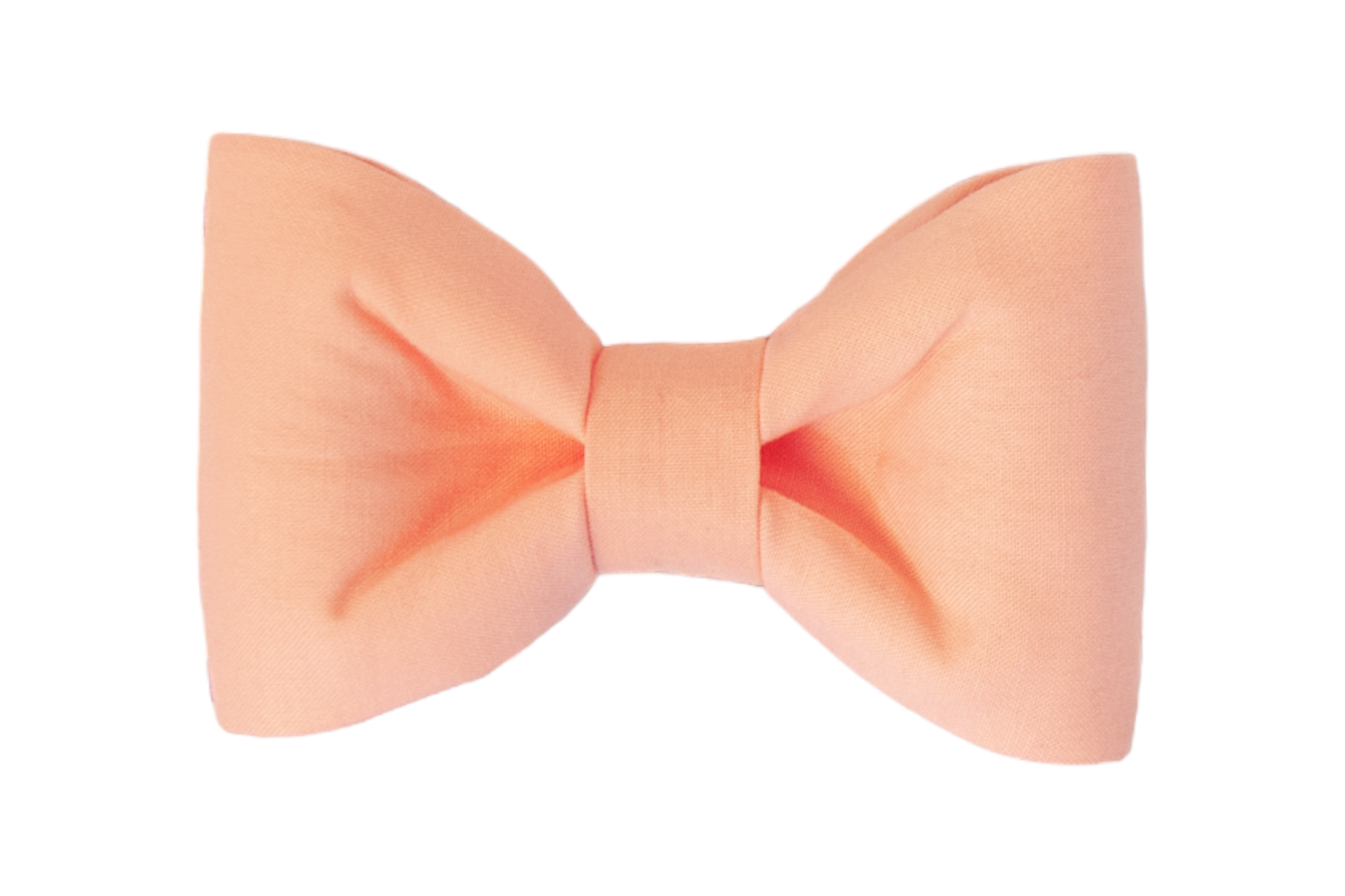 Soft peach pink fabric bow tie with a classic shape. The bow is full and gently gathered at the middle, ideal as a stylish and classic pet accessory.