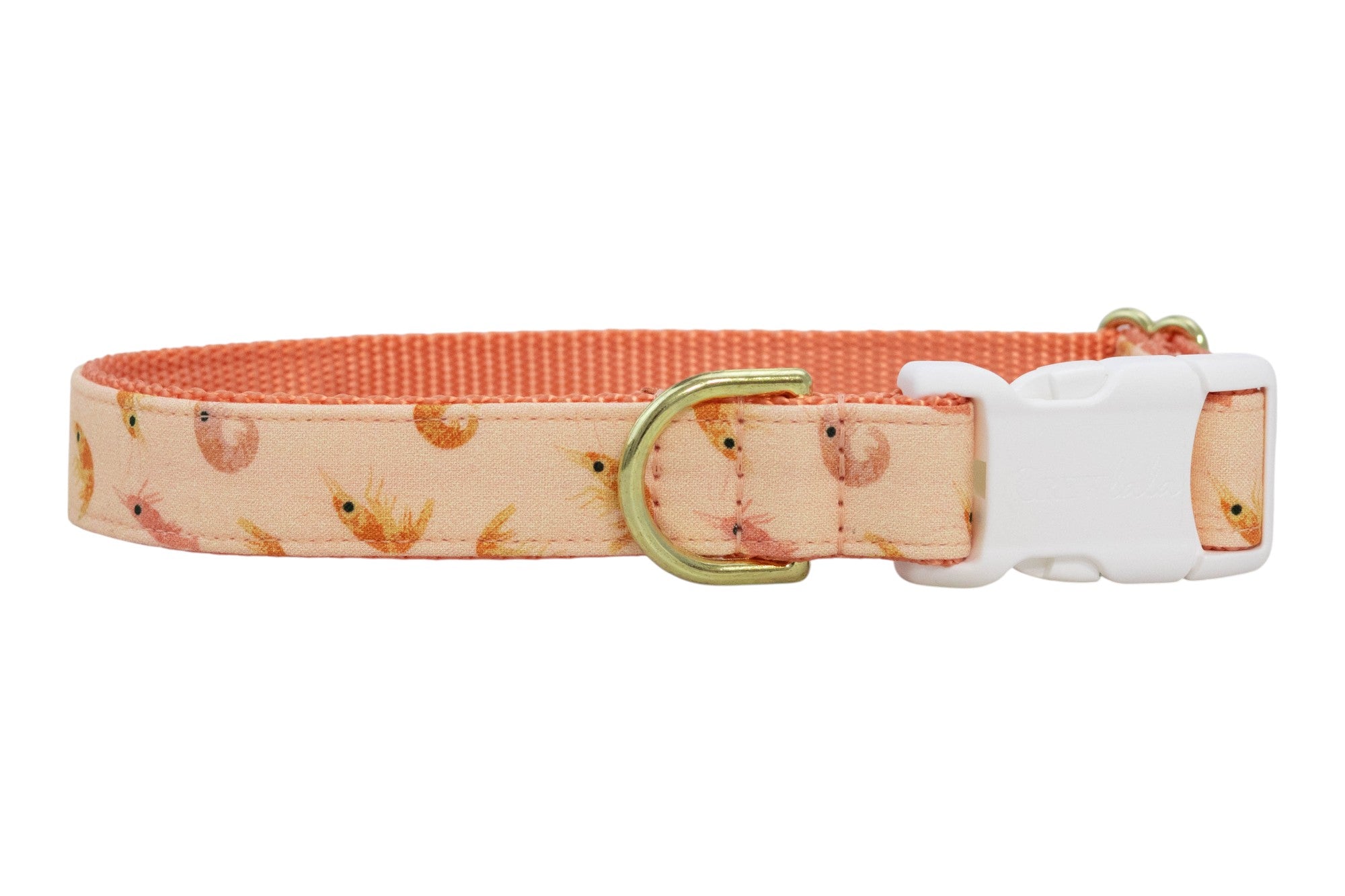 Adjustable peach dog collar with delicate shrimp print and sturdy white buckle closure.