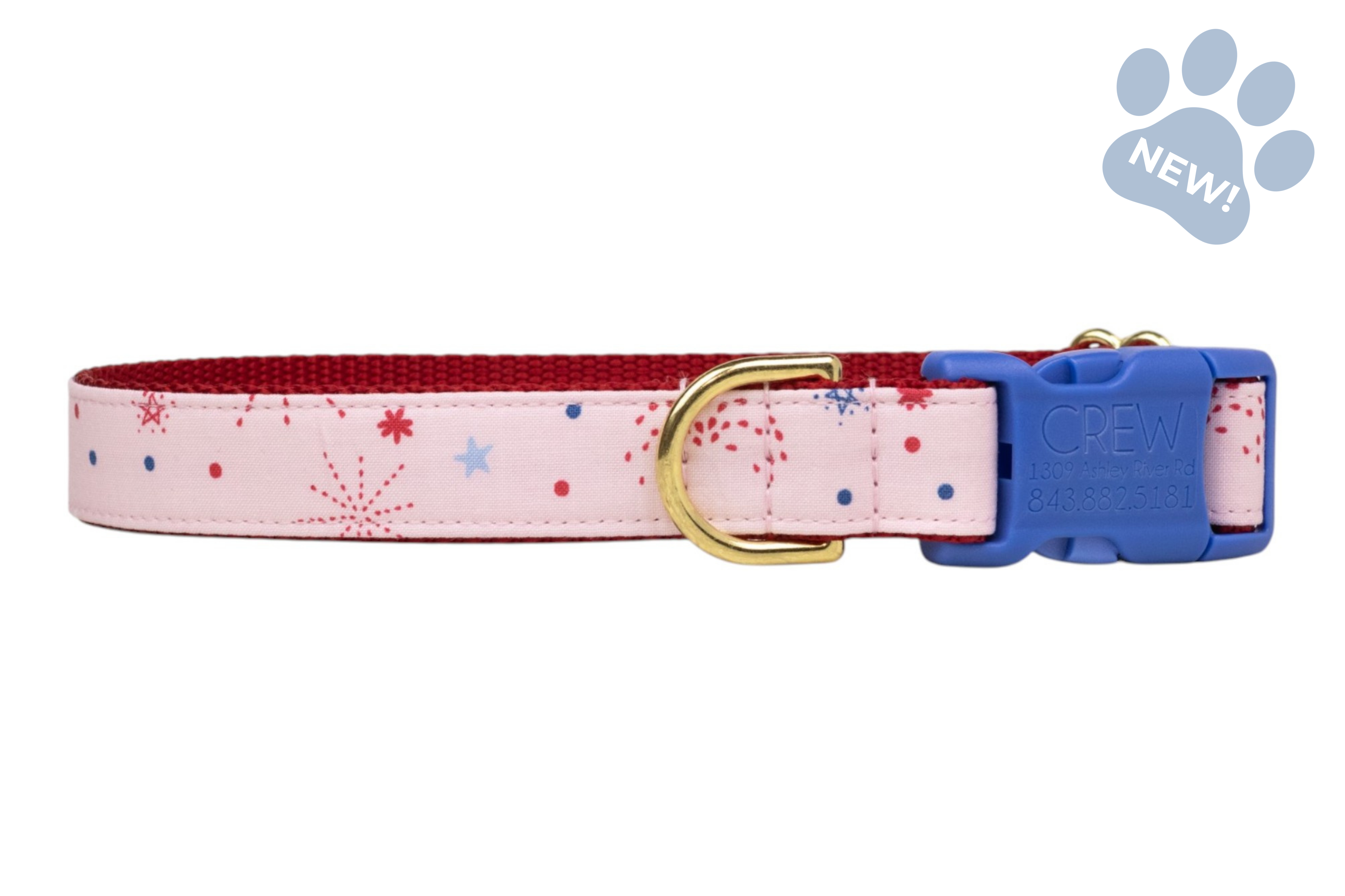 Pink fabric dog collar with scattered red and blue firework-style bursts, accented by a blue plastic buckle and metal D ring.