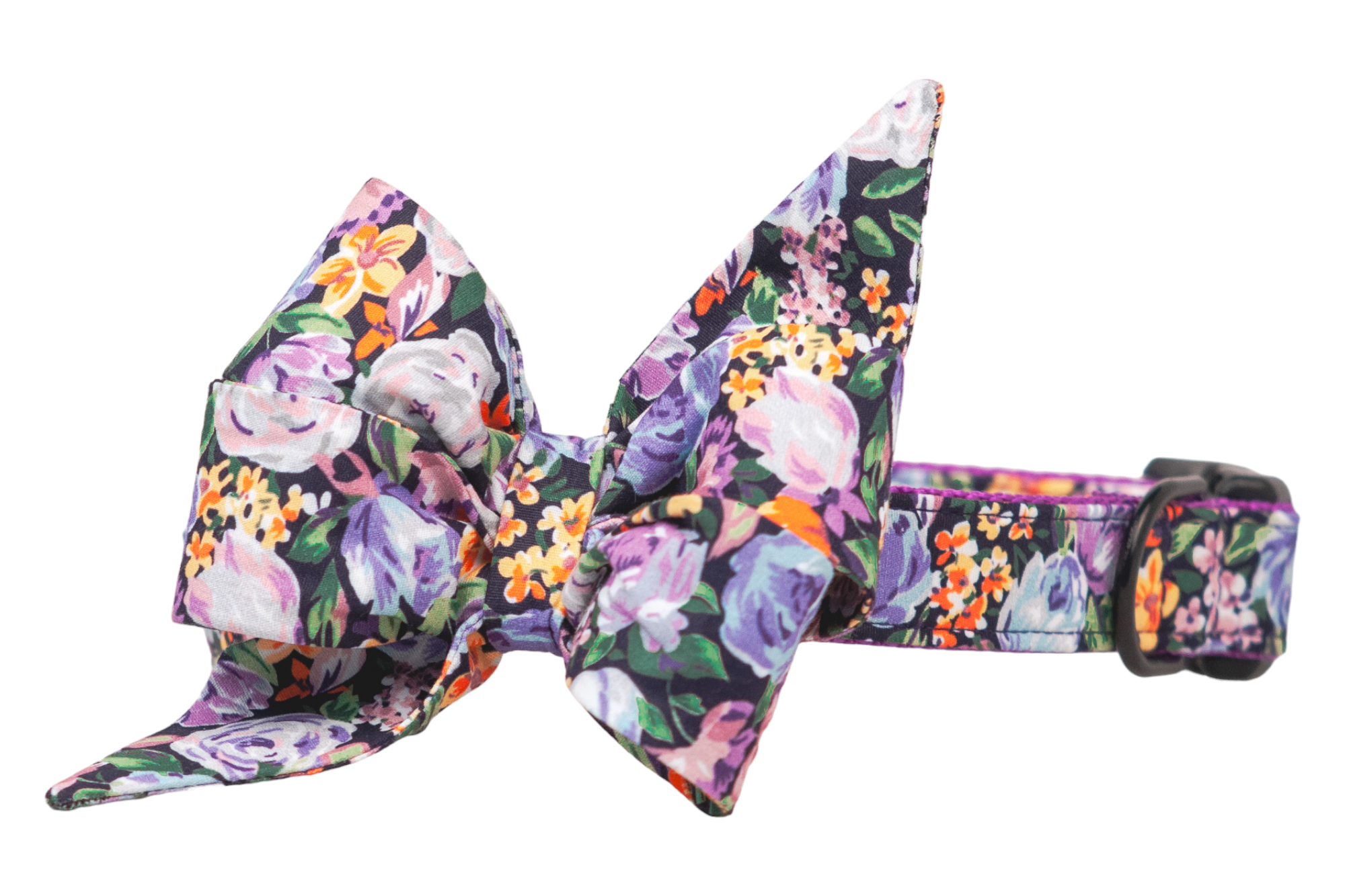 Floral dog collar with an oversized decorative belle bow in matching fabric, printed with multicolored flowers on a dark base. The belle bow has dramatic, pointed ends and a voluminous shape, paired with a D-ring and adjustable fit.