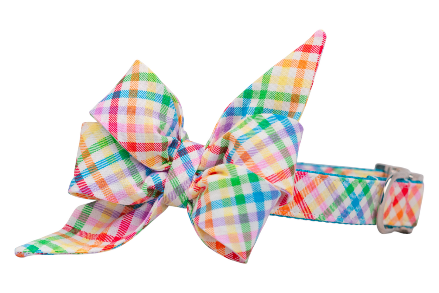 Fashionable dog collar adorned with a vibrant, large matching belle bow that includes long pointed tails, all in a colorful plaid design with rainbow tones and silver-toned clasp and hardware.