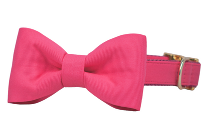 Chic dog collar in bold pink with a matching bow tie, crafted from textured fabric and detailed with gold-tone accents—ideal for stylish pets on special occasions or everyday charm.