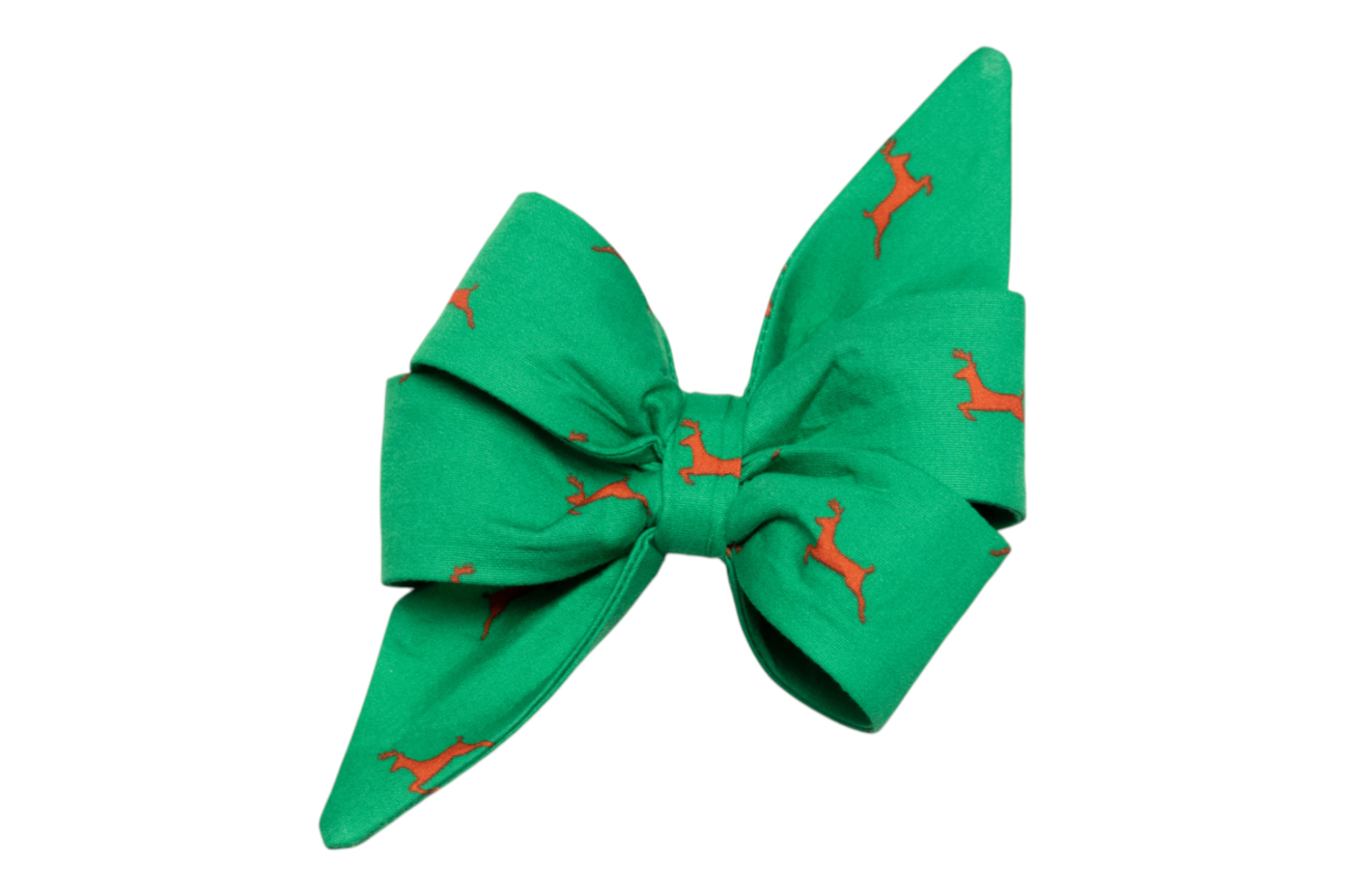 An oversized holiday-themed dog belle bow with a bright green background and repeating reindeer print. The structured design includes pleated loops and elongated tapered tails.
