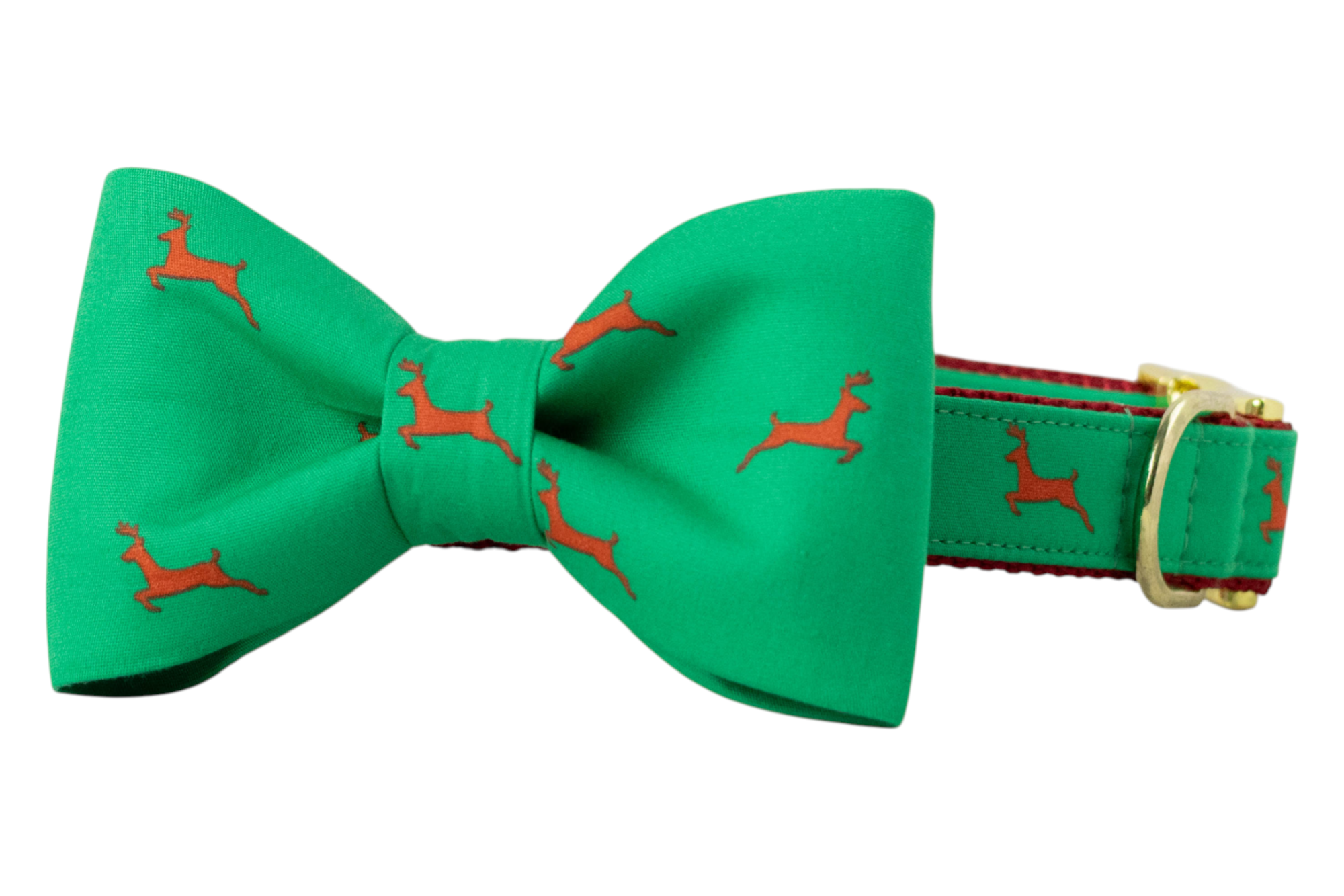 A green dog collar with an attached matching bow tie, both printed with reindeer silhouettes. The collar includes a nylon woven underside and metal hardware.