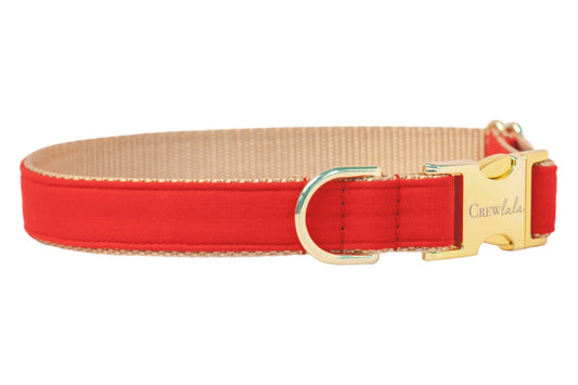 Sleek and stylish red dog collar with tan webbing backing and stitching, finished with a metallic gold clasp and matching D-ring for leash attachment.