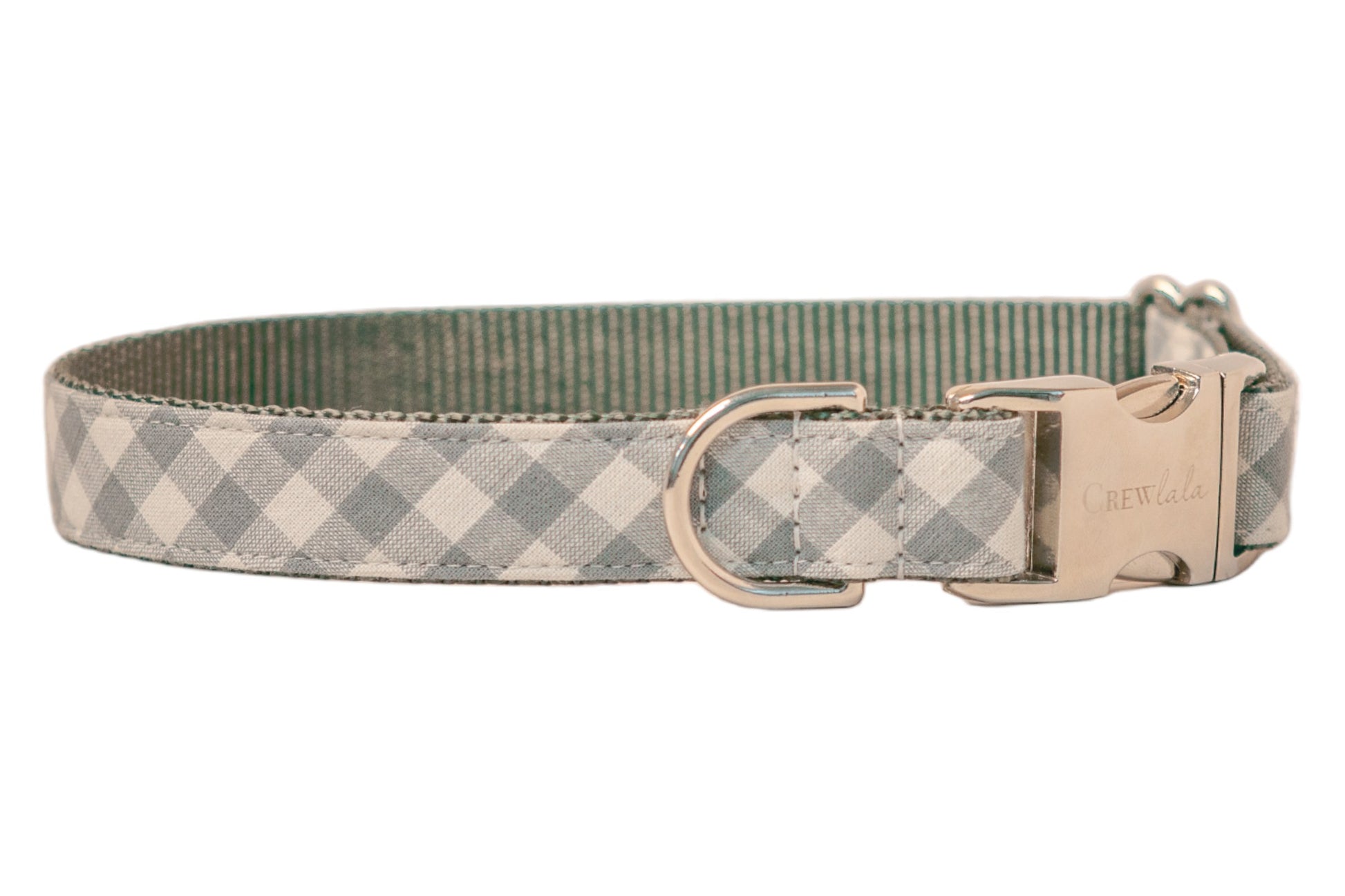 Stylish dog collar in pale gray gingham design, mounted on strong gray woven webbing for durability. The hardware includes a shiny clasp engraved with “Crewlala,” a robust D-ring for leash connection, and a metal sizing slider. Clean, even stitching outlines the collar, highlighting its neat, tailored construction.