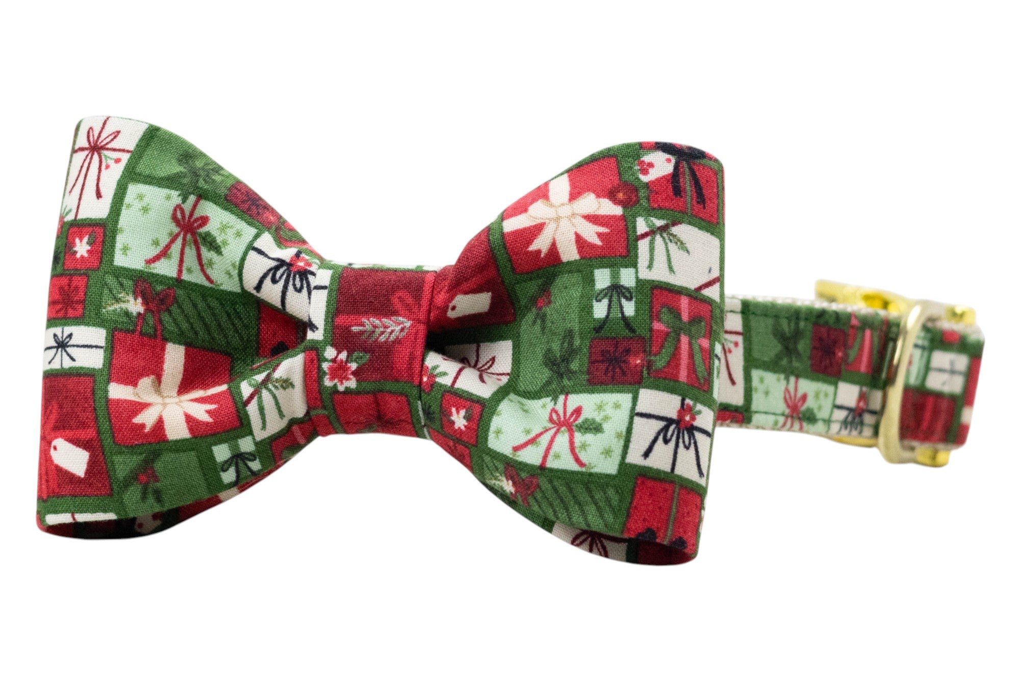 Classic dog bow tie collar with a repeating holiday pattern of colorful gift boxes, each wrapped with ribbons and bows. The structured bow tie sits at the front of the matching adjustable collar, which is fitted with metal hardware including a side-release buckle and D-ring.