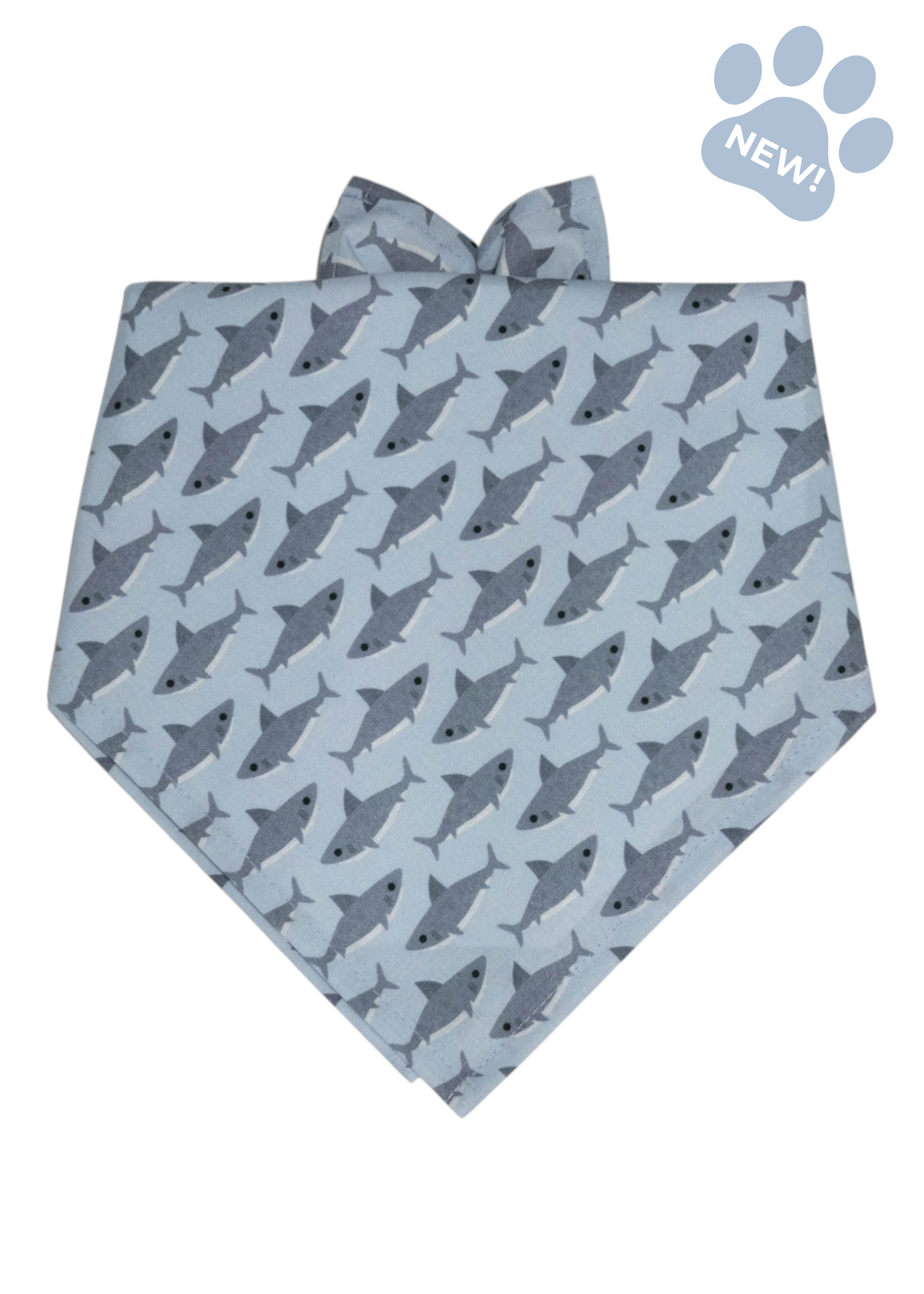 Light blue dog bandana with a playful pattern of small gray sharks, arranged in diagonal rows across the fabric.