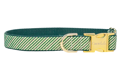 A festive dog collar featuring diagonal green stripes, resembling a candy cane pattern with a holiday twist. The collar is reinforced with dark green nylon webbing and includes polished hardware: a side-release buckle engraved with "Crewlala" and a sturdy D-ring.