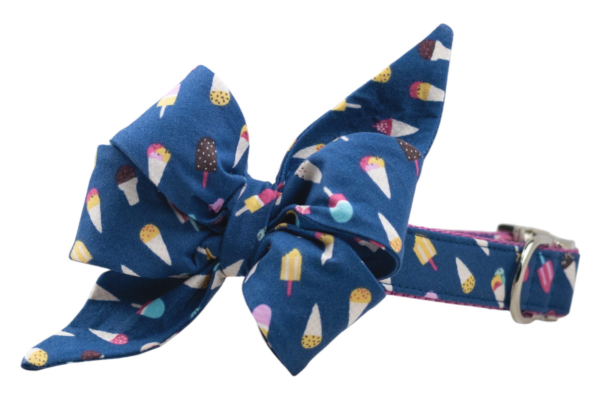 A blue dog collar with an oversized decorative belle bow made of fabric printed with colorful ice cream cones and popsicles. The bow features dramatic pointed loops and tails, and the matching collar includes silver metal hardware with pink inner webbing.