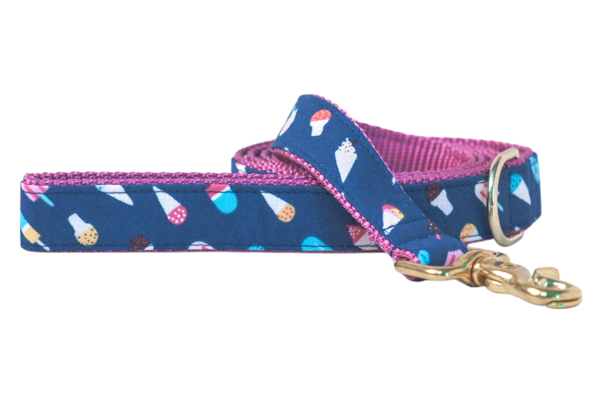 Stylish dog leash with a whimsical ice cream  and popsicle print on a blue fabric exterior and contrasting pink woven backing. The leash includes a brass-colored swivel clasp and metal D-ring, suggesting high-quality construction and fun summer vibes.