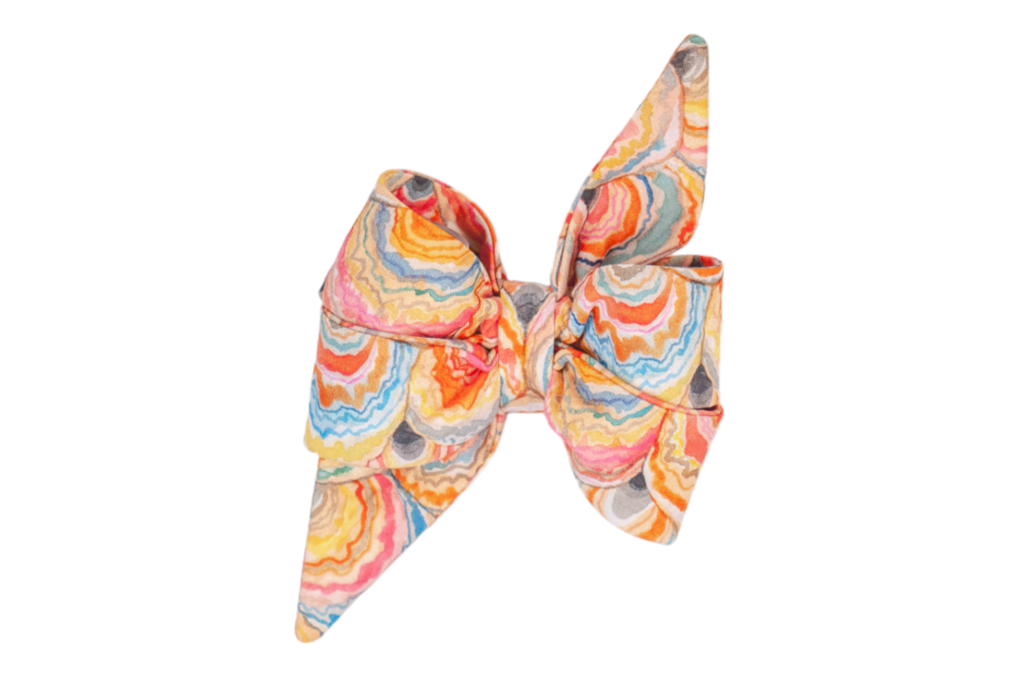 Fabric feminine belle bow for dogs in a vivid multicolor seashell print, styled with a full shape and extended tapered tips.