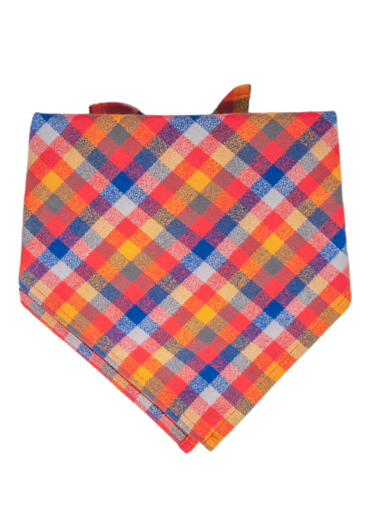  Dog bandana featuring a vivid plaid design with alternating red, orange, blue,  squares. The bandana is hemmed along all edges, with a folded top edge creating a channel for tying around your pup's neck.
