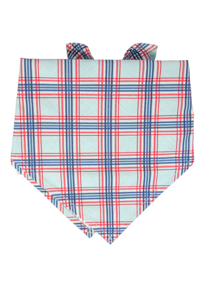Close-up of a stylish dog bandana with a patriotic-inspired plaid print in red, white, and blue. The fabric is folded into a pointed triangle.