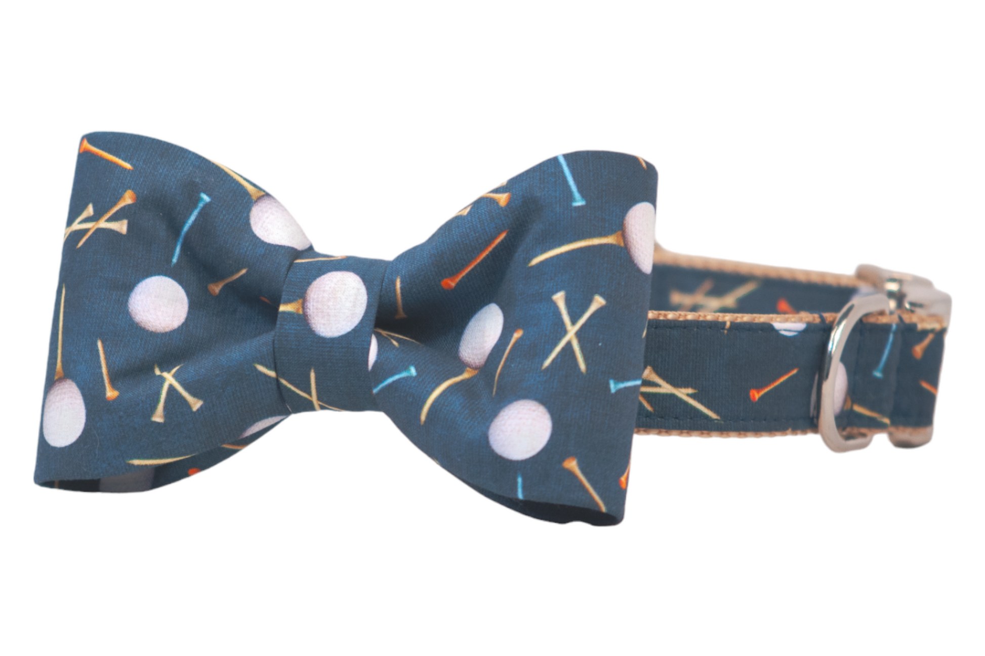 A dark blue dog collar with a matching attached bow tie, both printed with a playful pattern of white golf balls and multicolored tees in orange, yellow, and blue. The bow tie is neatly centered and symmetrical, giving the accessory a polished and sporty look. The collar is lined with tan webbing and features a shiny silver D-ring and buckle hardware.
