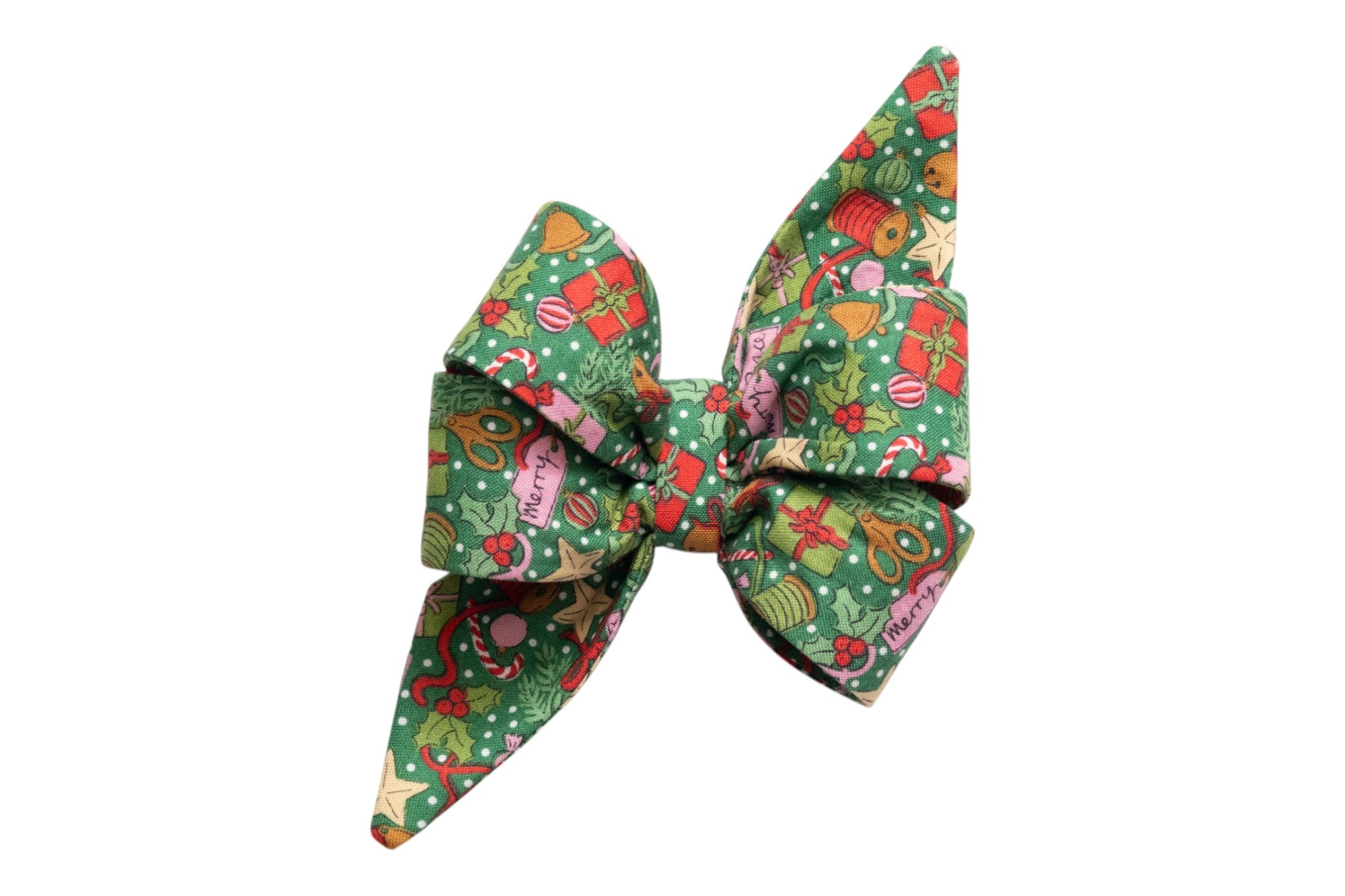 Festive green belle bow featuring a vibrant print of presents, holly, stars, candy canes, ornaments, and tags reading “Merry” and “Peace,” accented with snowy dots.