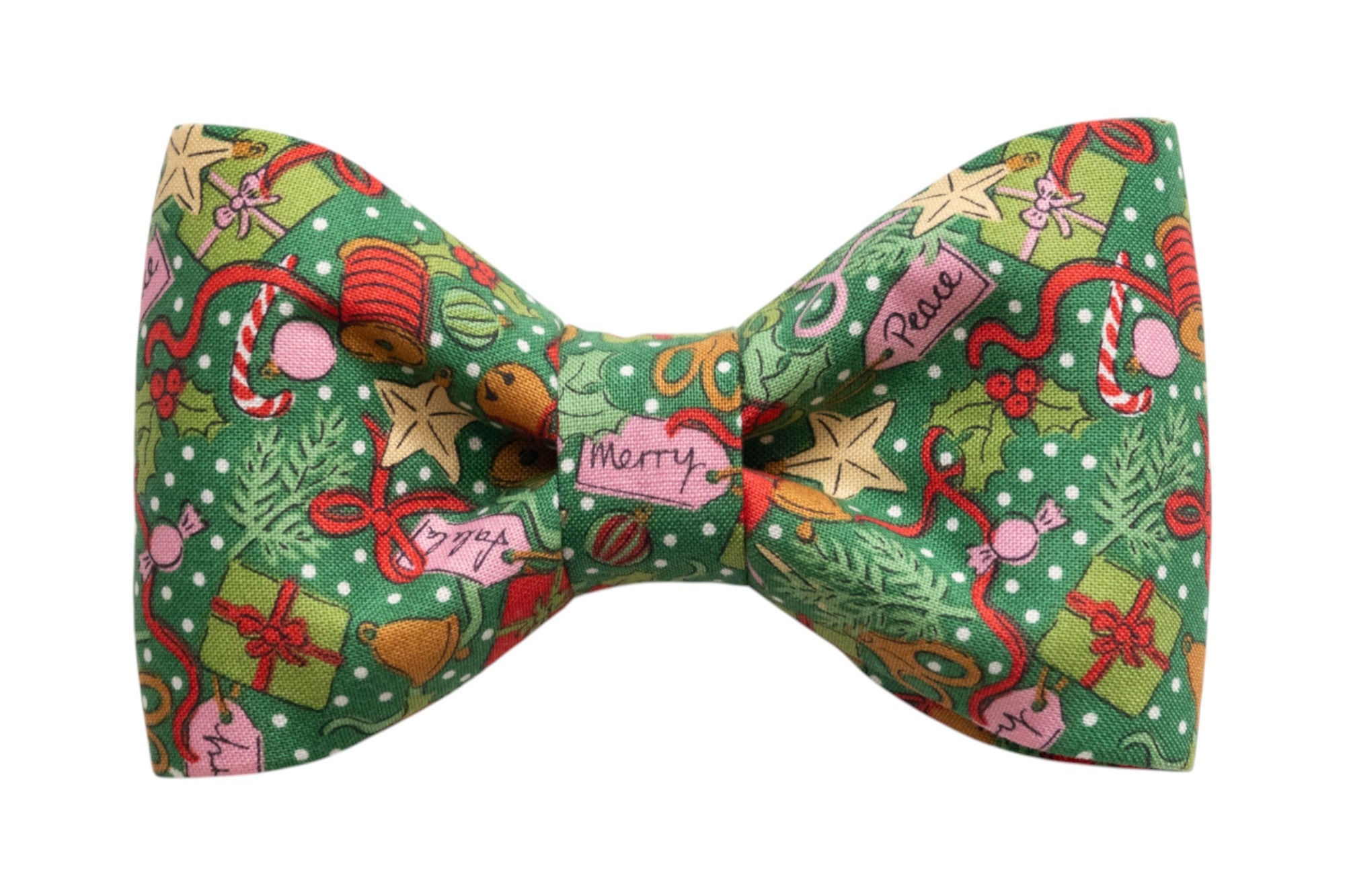 Green fabric bow tie patterned with colorful Christmas icons including gifts, candy canes, stars, holly, and holiday tags reading “Merry” and “Peace,” perfect for your dog's festive winter look.