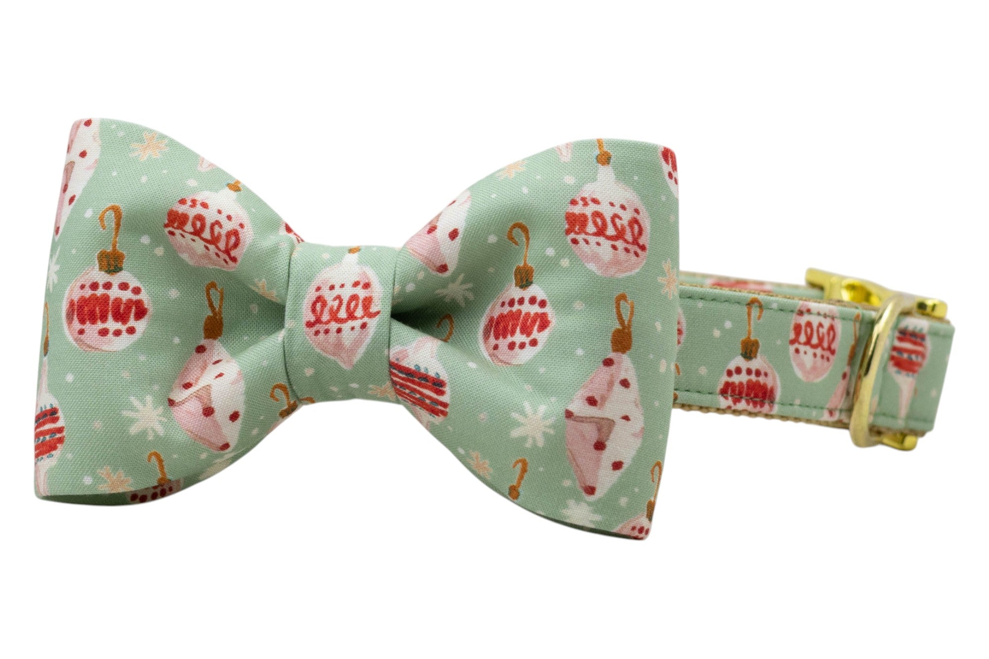 A festive dog collar with an attached matching bow tie, made from mint green fabric with  Christmas ornaments, hooks, and snowflakes. The bow tie is centered and symmetrical, adding a polished holiday look. The collar includes metal hardware for adjustment and accessory attachment.