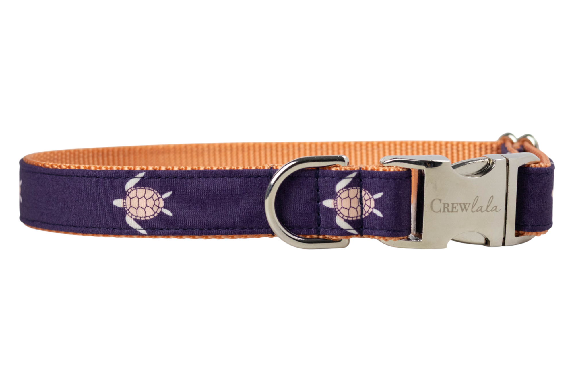 A dark purple dog collar featuring a repeating pattern of sea turtles with flippers and shell outlines. The collar has a bright orange woven backing, a shiny silver D-ring for leash attachment, and a sleek silver buckle clasp engraved with the name "Crewlala."