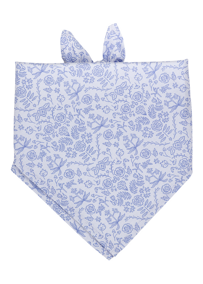 Soft cotton bandana in pale lilac, decorated with intricate floral illustrations in blue, perfect for Spring. The bandana has a pointed bottom edge and two small tied corners at the top.