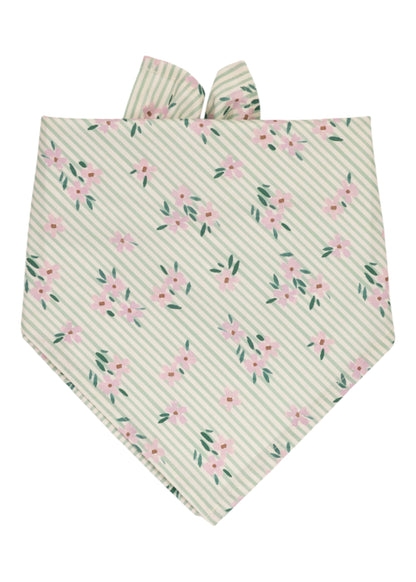 Striped green and white dog bandana decorated with scattered pink flowers and leafy green accents, folded into a triangle with two soft fabric tips at the top.