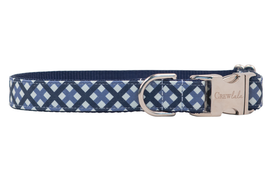 Blue plaid patterned dog collar with a buckle engraved with the word “Crewlala,” featuring a durable woven interior and a sturdy silver D-ring for leash or tag attachment.