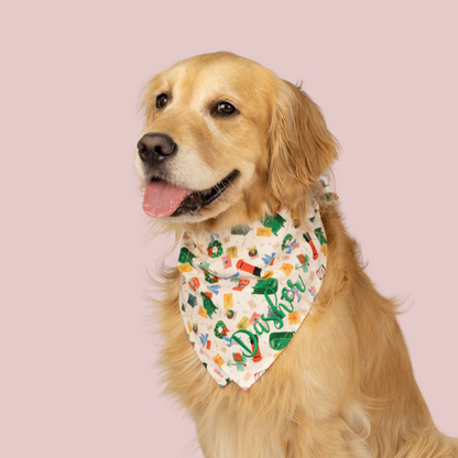 Adorable Retriever in a festive custom dog bandana with colorful Christmas items and green “Dasher” embroidery, posed against a light backdrop.