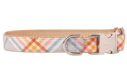 A dog collar made of soft flannel pastel plaid fabric featuring diagonal stripes. The collar has a tan nylon backing, a metal D-ring for leash attachment, and metal side-release buckle engraved with the brand name “Crewlala.”