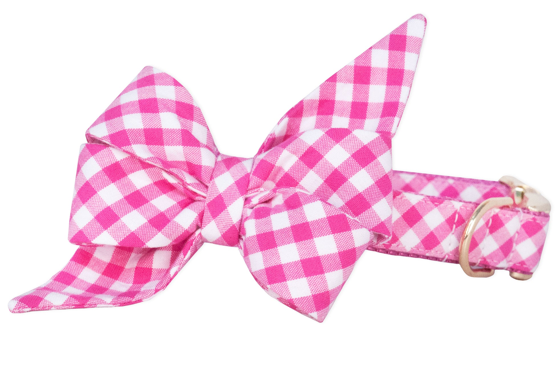 Close-up of a dog collar in a bright fuchsia pink and white checkered pattern with an oversized double belle bow attached. The belle bow has two full, symmetrical loops and two angular tails pointing diagonally. 