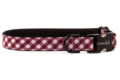 A classic dog collar in maroon with sleek black webbing and matte black hardware. A stylish, modern twist on a timeless plaid pattern.