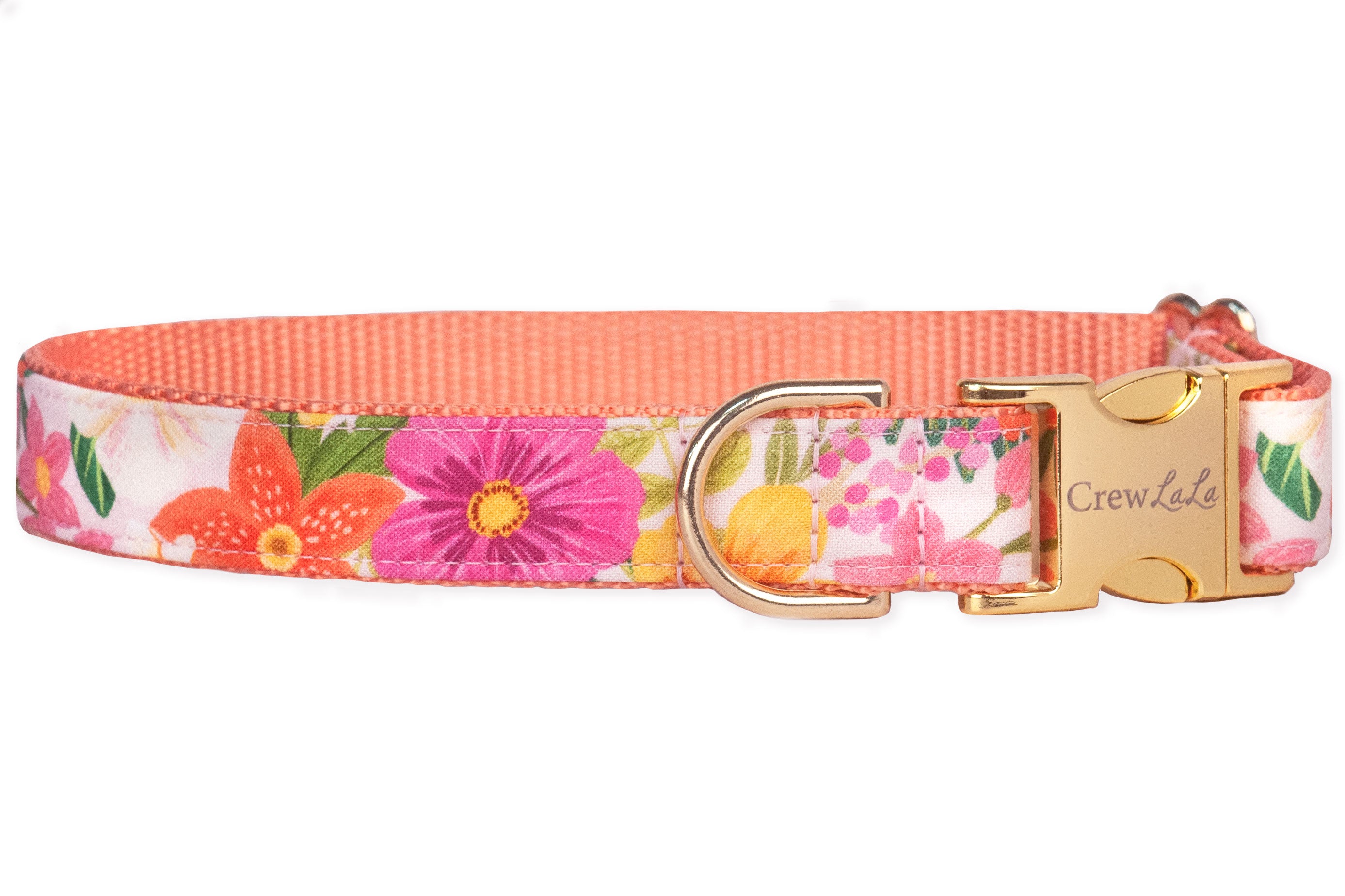 A colorful dog collar made from fabric printed with vibrant summer flowers—such as orange lilies, fuchsia daisies, yellow blooms, and pink clusters—set against a pale background. It includes a gold-tone buckle clasp engraved with “Crew LaLa,” a matching D-ring.