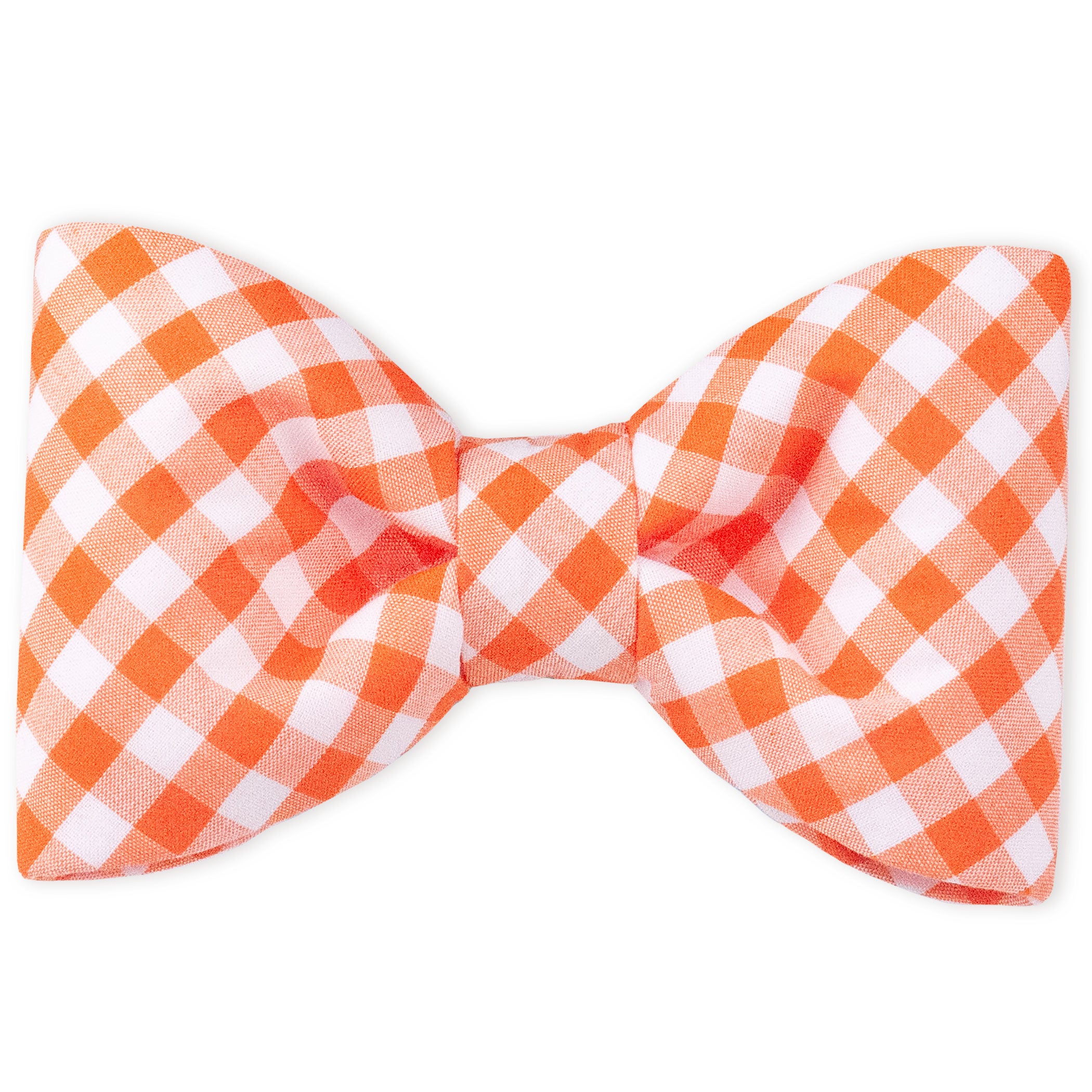 An orange plaid bow tie with clean lines and a full-bodied shape, designed to attach to a dogs collar. The bold plaid makes it perfect for fall strolls, family photos, or just fetching compliments.