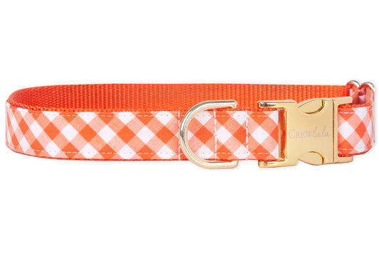 This cheerful dog collar features a bright orange plaid fabric with crisp white checks, lined with sturdy orange webbing. Finished with gold-tone hardware, it’s a picnic-ready accessory for plaid-loving pups.
