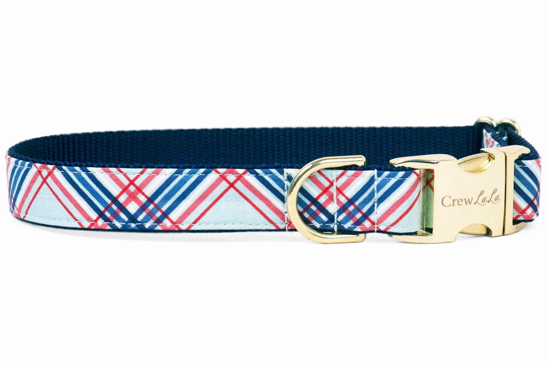 A dog collar with a red, white, and blue plaid pattern on a light blue background. The collar has a navy blue interior lining and is finished with gold hardware, including a D-ring and a side-release buckle engraved with the brand name "Crew LaLa."