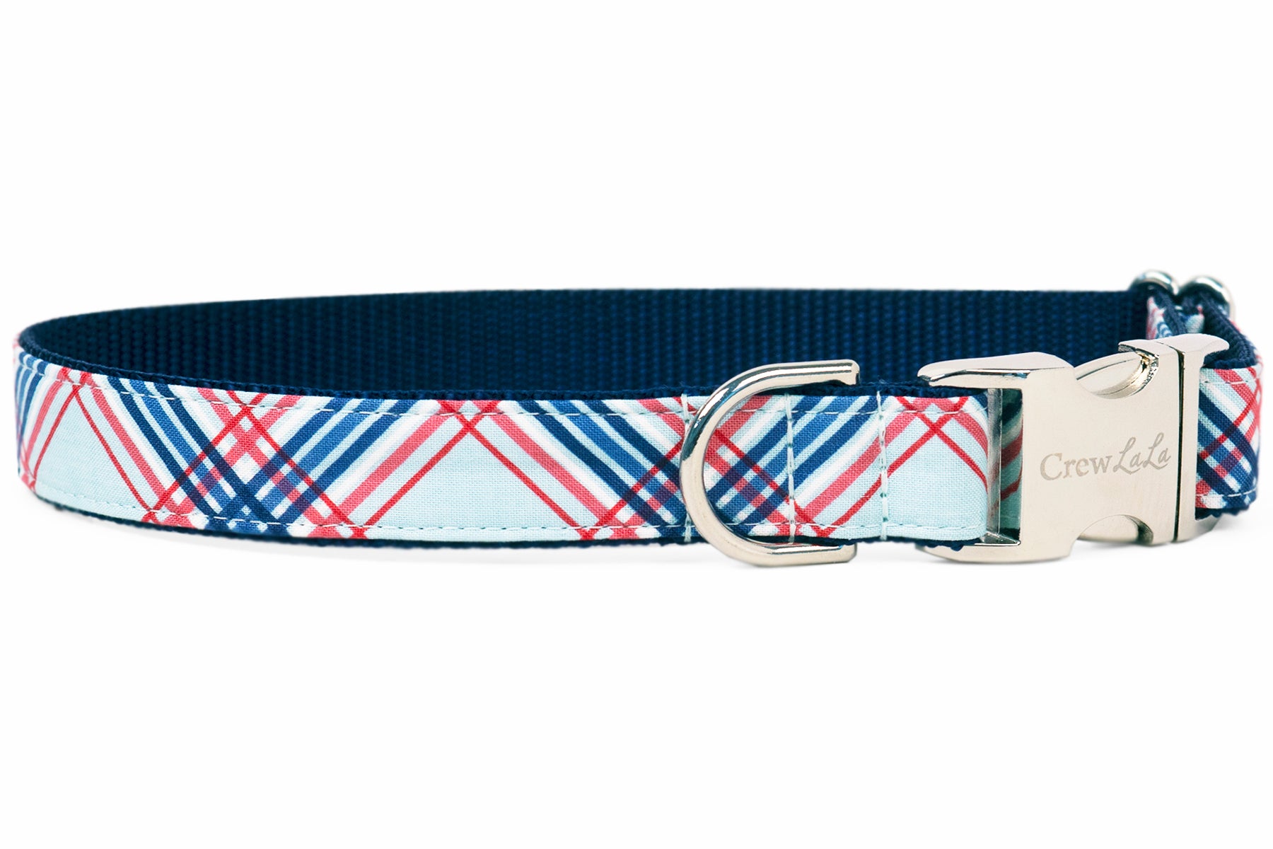 A dog collar with a red, white, and blue plaid pattern on a light blue background. The collar has a navy blue interior lining and is finished with silver hardware, including a D-ring and a side-release buckle engraved with the brand name "Crew LaLa."