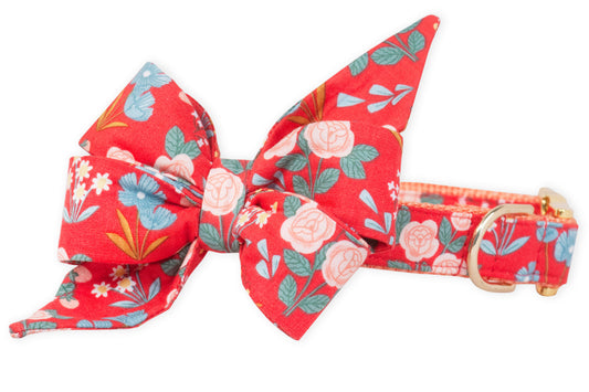 A vibrant red dog collar with a dramatic matching belle bow, adorned with pastel roses, cheerful wildflowers, and foliage—crafted for pups who love to strut their stuff in botanical style.